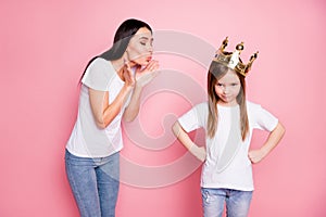 Photo of overjoyed obsessed mommy blowing kisses little angry spoiled daughter with crown on head boast person wear