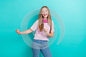 Photo of overjoyed positive girl closed eyes enjoy dancing chilling isolated on teal color background