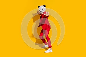 Photo of panda guy crazy party funny dance wear mask red tux tie shoes isolated on yellow color background
