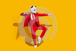 Photo of panda guy dance motion look empty space wear mask red tux tie shoes isolated on yellow color background