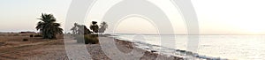 Photo panorama. Beautiful seascape of sunrise over the Red Sea in the Gulf of Aqaba. Dahab, South Sinai Governorate, Egypt