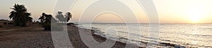 Photo panorama. Beautiful seascape of sunrise over the Red Sea in the Gulf of Aqaba. Dahab, South Sinai Governorate, Egypt