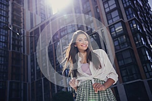 Photo of peaceful carefree girl toothy smile good mood free time weekend excursion downtown outdoors