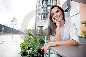 Photo of peaceful gorgeous lady sit coffee shop table waiting order daydreaming imagine free time outside