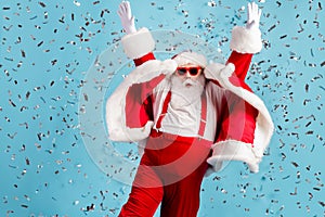 Photo of pensioner old man grey beard carefree raise hands waving dance careless flying confetti wear santa x-mas