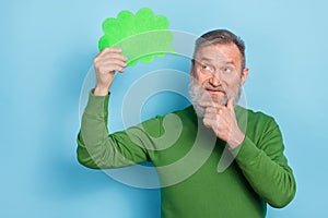 Photo of pensive middle aged man hold paper card speech bubble analyze message isolated blue color background