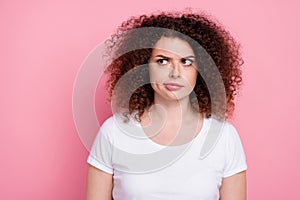 Photo of pensive woman with perming coiffure dressed white t-shirt look at proposition empty space isolated on pink photo