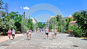 Photo of people walking on Dionysiou Areopagitou in Athens, Greece.