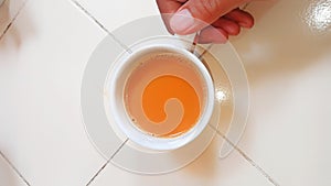 photo of a person holding a cup of coffee