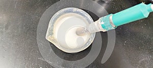 Photo of pH testing of oxidised starch solution in a factory laboratory