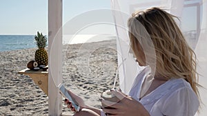 Photo on phone in memory, coconut in hands of girl, young