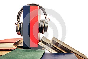 Photo of a pile of books and headphones on top of it