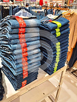 This is a photo of a pile of jeans in a supermarket