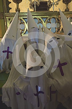 Piled White Cone-shaped Capirotes Waiting for Procession photo