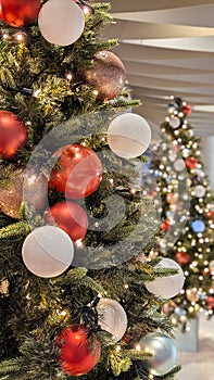 Photo with a pine tree adorned with colorful baubles. Concepts of decorations, merriness, yuletide, festive spirit. photo