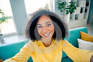 Photo of pleasant toothy beaming nice woman with perming coiffure wear yellow long sleeve doing selfie on smartphone at