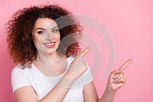 Photo of pleasant woman with perming coiffure dressed white t-shirt directing at proposition empty space isolated on photo