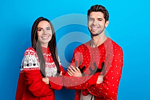 Photo portrait of attractive young couple folded arms confident pose dressed x-mas ornament red sweaters isolated on