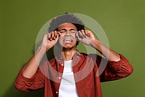 Photo portrait of attractive young man crying tears weep dressed stylish brown clothes isolated on khaki color