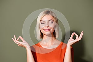Photo portrait of attractive young woman closed eyes meditate dressed stylish orange clothes isolated on khaki color