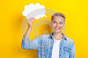 Photo portrait of attractive young woman hold look comics speech cloud dressed stylish denim clothes isolated on yellow