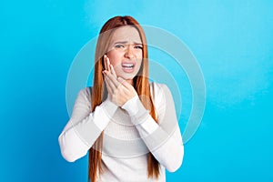 Photo portrait of attractive young woman touch cheek suffer toothache dressed stylish white clothes isolated on blue