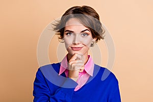 Photo portrait of attractive young woman touch chin confident minded wear trendy blue clothes isolated on beige color