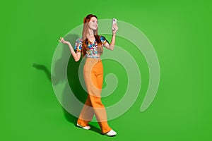 Photo portrait of attractive young woman walk video recording dressed stylish retro clothes isolated on green color