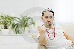 Photo of portrait of bearded man showing his fist.