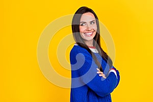 Photo portrait of brunette hair lady wearing blue knitted jumper crossed arms look empty space minded  on yellow