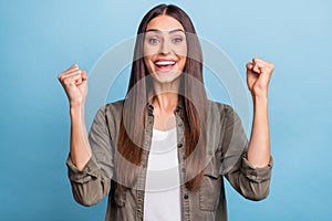 Photo portrait brunette woman gesturing like winner smiling isolated pastel blue color background