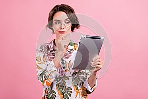 Photo portrait business woman in shirt glasses keeping tablet contemplated thoughtful isolated pastel pink color