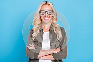 Photo portrait business woman wearing glasses grey shirt smiling crossed hands isolated pastel blue color background