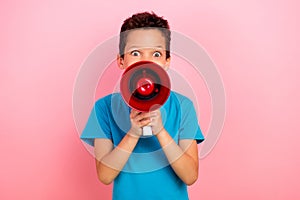 Photo portrait of charming small boy hold megaphone scream shouting wear trendy blue garment isolated on pink color
