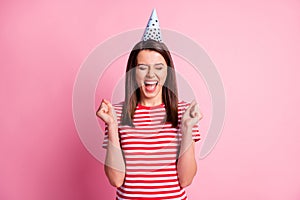 Photo portrait of cheerful happy girl smiling shouting screaming surprised with closed eyes isolated on pastel pink