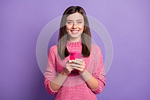 Photo portrait of cheerful nice girl typing comment in inernet isolated on vivid violet color background