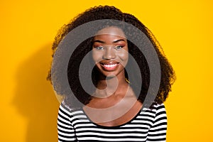 Photo portrait of cheerful pretty girl smiling in striped shirt isolated on bright yellow color background