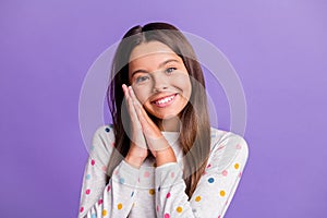 Photo portrait of cute girl holding hands together under ear cheek isolated on vivid violet colored background