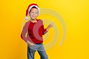 Photo portrait of cute little boy point copyspace christmas north pole wear trendy red knitwear look isolated on yellow