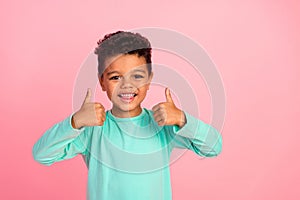 Photo portrait of cute little boy show thumbs up good quality wear trendy aquamarine clothes isolated on pink color