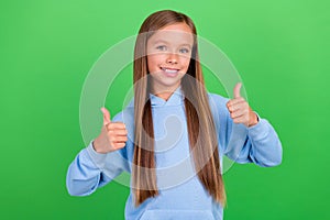 Photo portrait of cute little girl show double thumb up positive feedback dressed trendy blue sportswear  on