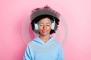 Photo portrait of cute school girl closed eyes listen calm music meditate dressed stylish blue clothes isolated on pink