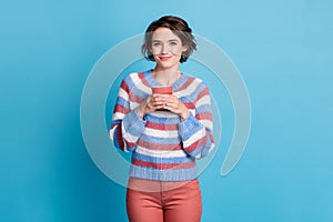 Photo portrait of cute smiling girl keeping red mug wearing casual clothes isolated on bright blue color background
