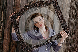 Photo portrait of a cute young lady in a wooden frame, excited photo, wearing a stylish purple jacket.