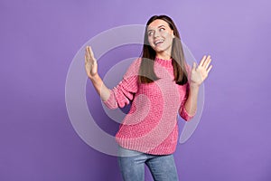 Photo portrait of dancing pretty young woman enjoying discotheque looking empty space isolated on vibrant violet color