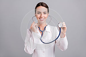 Photo portrait female doctor with sthethoscope listening heart beat isolated grey color background