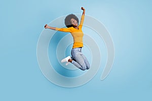 Photo portrait full body of excited girl celebrating jumping up isolated on pastel blue colored background