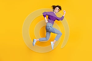 Photo portrait full body side profile view of girl running jumping up isolated on vivid yellow colored background