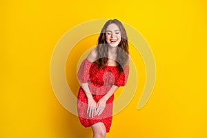 Photo portrait of funky girl laughing in red fancy printed dress isolated bright yellow color background