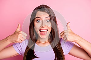 Photo portrait of funny crazy girl showing like gesture thumb-up on both hands isolated on pastel pink color background